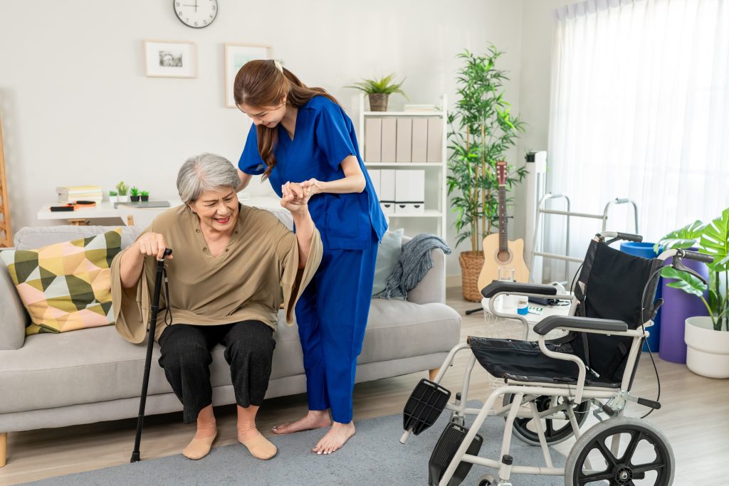Home nurse assisting elderly patient at home in Dubai